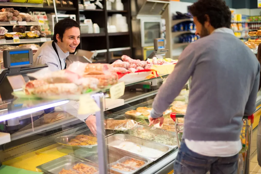 Supermarket Shopkeeper serving a customer in a grocery store